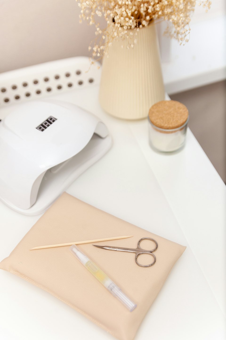 Manicure station tools arranged neatly on a white table.